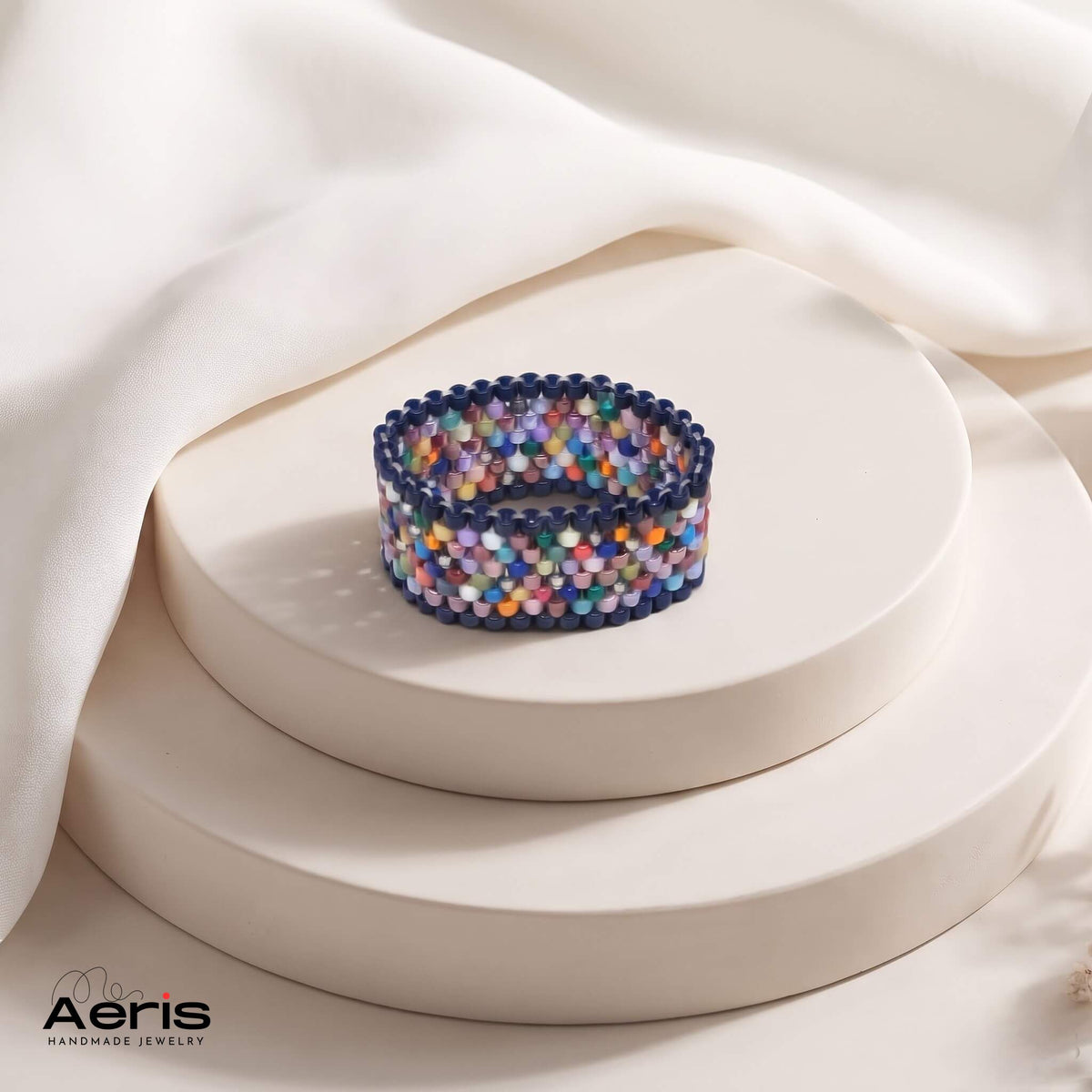 Inel handmade mozaic multicolor din margele japoneze Miyuki, prezentat pe un soclu ceramic